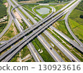 Drone shot a large highway interchange crossing over green farmlands in Thailand 130923616