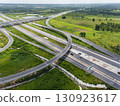 Drone shot a large highway interchange crossing over green farmlands in Thailand 130923617