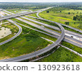 Drone shot a large highway interchange crossing over green farmlands in Thailand 130923618
