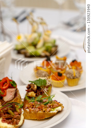 A beautifully arranged plate of assorted bruschetta, canapes, and marinated appetizers A beautifully arranged plate of assorted bruschetta, canapes, and marinated appetizers 130923940