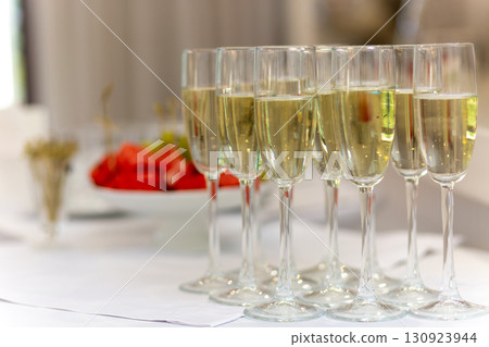 Festive table with sweet snacks, fruits, and champagne flutes Festive table with sweet snacks, fruits, and champagne flutes 130923944