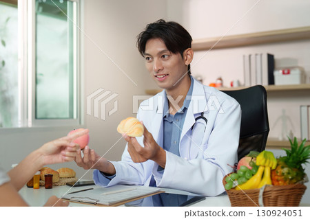 Nutrition Guidance: Doctor Offering Healthy Treats During Consultation 130924051