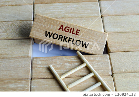 A wooden block marked AGILE WORKFLOW on steps reflecting adaptability, innovation, iteration, progress and efficiency. 130924138