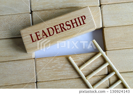 A wooden block ladder arrangement with the word LEADERSHIP representing growth direction and success. 130924143