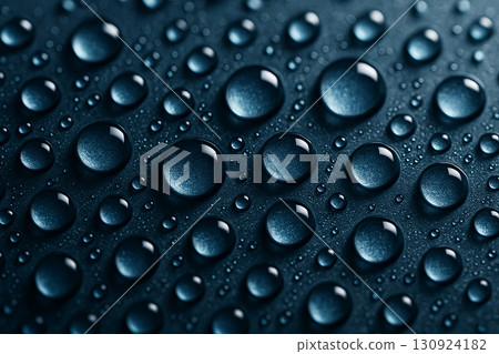 Detailed water droplets clustered on a dark navy-blue surface giving a shiny reflective effect. Detailed water droplets clustered on a dark navy-blue surface giving a shiny reflective effect. 130924182