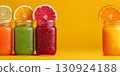 Citrus Juices in Mason Jars with Fruit Slices on Yellow Background 130924188