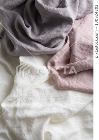 Sewing concept with pink, lilac and white linen fabric Sewing concept with pink, lilac and white linen fabric 130924802
