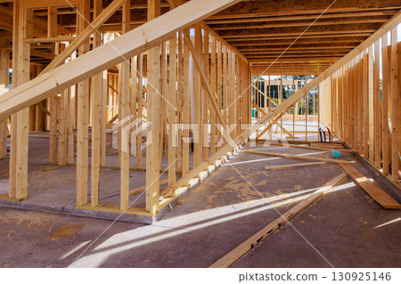 Construction site showing wooden framing for new house in progress during works daytime Construction site showing wooden framing for new house in progress during works daytime 130925146