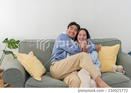 Winter brings happy couple enjoying indoor home, people share cozy family moments embracing warmly with cheerful smiles, creating beautiful memories during cold winter. 130925772