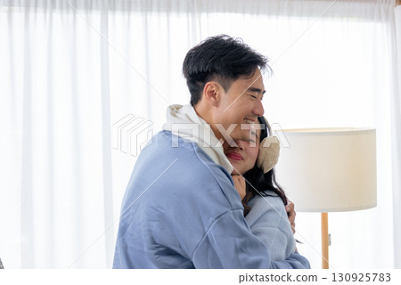 Winter day brings happy couple family people home for cozy indoor comfort sharing tender warm embrace feeling cheerful during cold winter season creating loving memories. 130925783