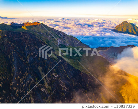 Aerial view of rock cliff at Kawah Ijen volcano with turquoise sulfur water lake at sunrise.Amazing nature landscape view at East Java, Indonesia. Natural landscape background 130927329
