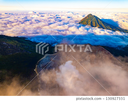 Aerial view of rock cliff at Kawah Ijen volcano with turquoise sulfur water lake at sunrise.Amazing nature landscape view at East Java, Indonesia. Natural landscape background 130927331