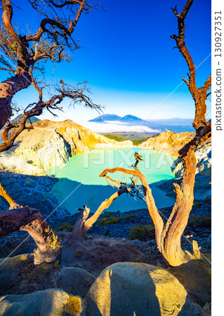 Aerial view of rock cliff at Kawah Ijen volcano with turquoise sulfur water lake at sunrise.Amazing nature landscape view at East Java, Indonesia. Natural landscape background 130927351