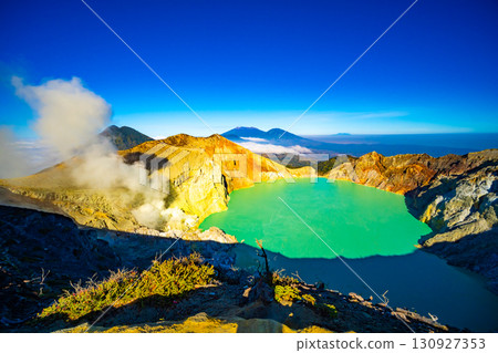 Aerial view of rock cliff at Kawah Ijen volcano with turquoise sulfur water lake at sunrise.Amazing nature landscape view at East Java, Indonesia. Natural landscape background 130927353