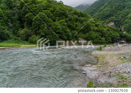 A strong river flows between the mountains of Georgia 130927630