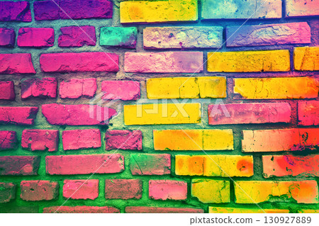 Colorful brick wall made of handmade clay bricks. Abstract bricks background. Bright pink green gradient colored 130927889