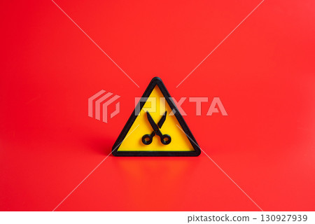 Scissors symbol. Concept of budget cutting or time reduction. Dismissal, layoffs. Used for austerity measures, cost reduction, unemployment, crisis management, and policy changes. 130927939