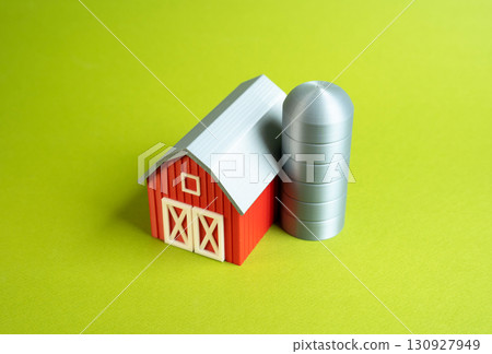 Farm barn on green background. Farming and agribusiness business concept. Sustainable agriculture, rural economy, food production. Investments in farming technology. Farm barn on green background. Farming and agribusiness business concept. Sustainable agriculture, rural economy, food production. Investments in farming technology. 130927949