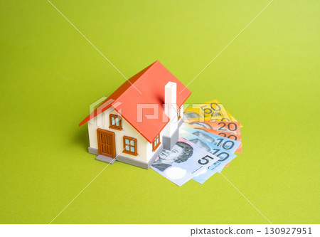 House and Australian banknotes. Buying a house, renting or selling, renovating a house, paying taxes, property valuation. Real estate market and housing investments. 130927951