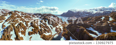 Mountain landscape in summer. Aerial view at glacier melted lake, mountains ridge, and highway. Nature park in Sauda municipality, Rogaland fylke. Beautiful nature of Norway. Horizontal banner Mountain landscape in summer. Aerial view at glacier melted lake, mountains ridge, and highway. Nature park in Sauda municipality, Rogaland fylke. Beautiful nature of Norway. Horizontal banner 130927975