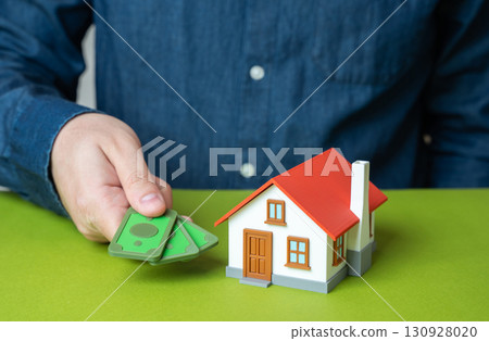 The man pays rent for housing. Payment of bills and utilities. Symbol of family budget, property expenses, household management and financial responsibility in everyday life. 130928020