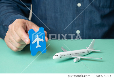 Man with ticket and passenger airliner. Buy ticket, booking. Symbol of travel industry, tourism growth, international flights, passenger services and global transportation. 130928023