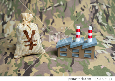 A military factory and a money bag with a yen or yuan symbol. Investments in the defense industry. Political instability in the Asian region. Topics include arms trade, strategy, and security. A military factory and a money bag with a yen or yuan symbol. Investments in the defense industry. Political instability in the Asian region. Topics include arms trade, strategy, and security. 130928045