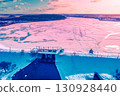 Aerial view of the frozen lake and dam in winter during sunset 130928440