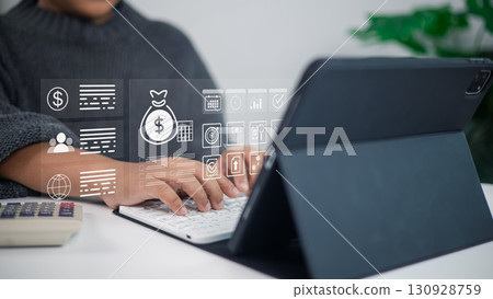 Businessman using tablet with digital finance and fintech icons for online banking and investment technology 130928759