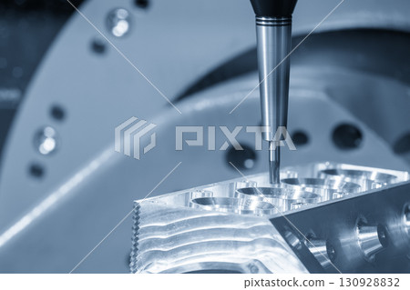 The 5-axis CNC milling machine cutting the aluminum engine block by solid ball nose end mill tool in the light blue scene. The 5-axis CNC milling machine cutting the aluminum engine block by solid ball nose end mill tool in the light blue scene. 130928832