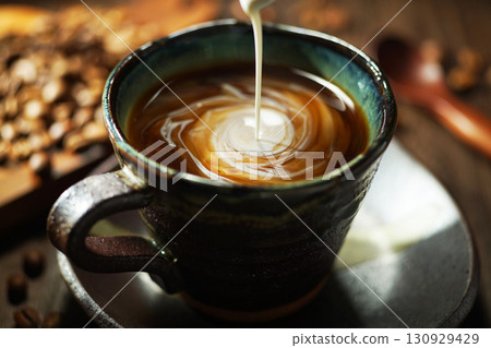 Fresh cream poured into coffee 130929429