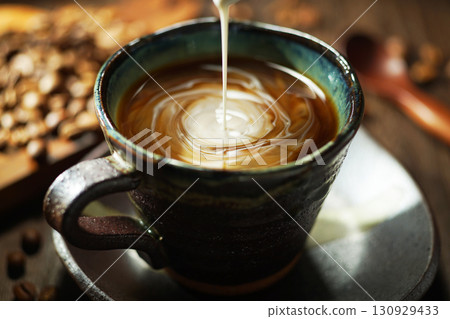 Fresh cream poured into coffee Fresh cream poured into coffee 130929433