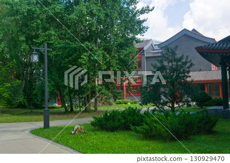Park in the center of the city with a street lamp and buildings 130929470