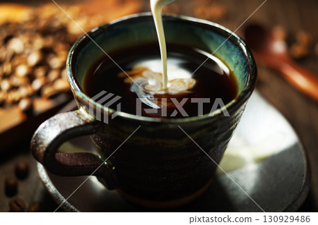 Fresh cream poured into coffee Fresh cream poured into coffee 130929486