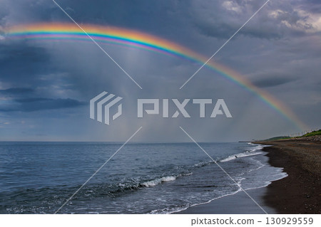 A fantastic rainbow appears over the sea after the rain A fantastic rainbow appears over the sea after the rain 130929559