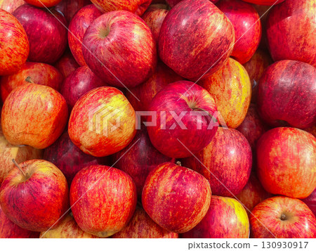 Fresh red apples piled together, showing vibrant colors and natural textures, perfect for healthy food, market, and agriculture concepts. 130930917