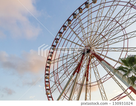 Shot of the ferris wheel, cloudy sky on the background Shot of the ferris wheel, cloudy sky on the background 130931024