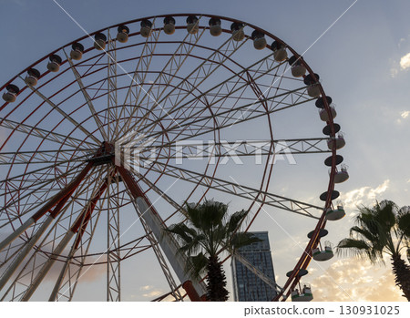 Shot of the ferris wheel, cloudy sky on the background Shot of the ferris wheel, cloudy sky on the background 130931025