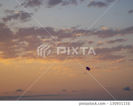 Shot of the person parasailing during sunset hour Shot of the person parasailing during sunset hour 130931158