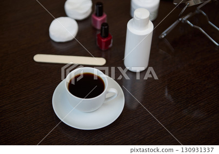 Cup of Coffee on a Wooden Table with Beauty Items Nearby Cup of Coffee on a Wooden Table with Beauty Items Nearby 130931337