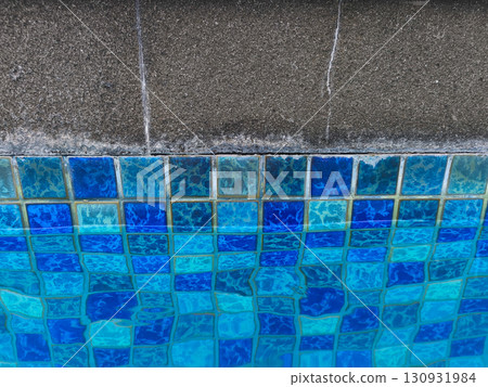 Modern pool design featuring checkerboard tiles and smooth concrete deck. Modern pool design featuring checkerboard tiles and smooth concrete deck. 130931984