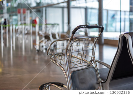 Empty airport luggage cart in Departures terminal in Madrid Barajas International Airport in Madrid, Spain Empty airport luggage cart in Departures terminal in Madrid Barajas International Airport in Madrid, Spain 130932326
