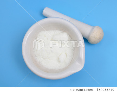 Metronidazole powder on blue background Metronidazole powder on blue background 130933249