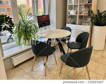 Meeting area in the company's office round white table and chairs. High quality photo Meeting area in the company's office round white table and chairs. High quality photo 130933407
