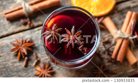 Mulled wine with star anise, cinnamon sticks and an orange slice in a rustic wooden setting, a cozy winter drink Mulled wine with star anise, cinnamon sticks and an orange slice in a rustic wooden setting, a cozy winter drink 130933835