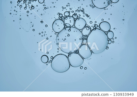 The texture of the hyaluronic serum on a blue background. A drop. 130933949