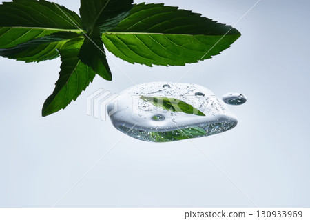 A drop of natural cosmetics with a mint leaf. 130933969