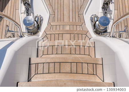 Teak stairs ladder on luxury yacht. Elements of yacht construction. Superyacht concept. Teak stairs ladder on luxury yacht. Elements of yacht construction. Superyacht concept. 130934003