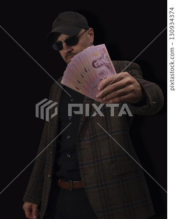 Currency notes displayed on a bright red surface showing detailed designs and denominations in a financial setting Currency notes displayed on a bright red surface showing detailed designs and denominations in a financial setting 130934374