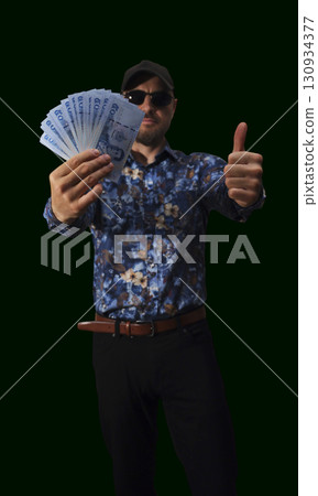 Cash displayed on a red background showcasing large denomination bills 130934377